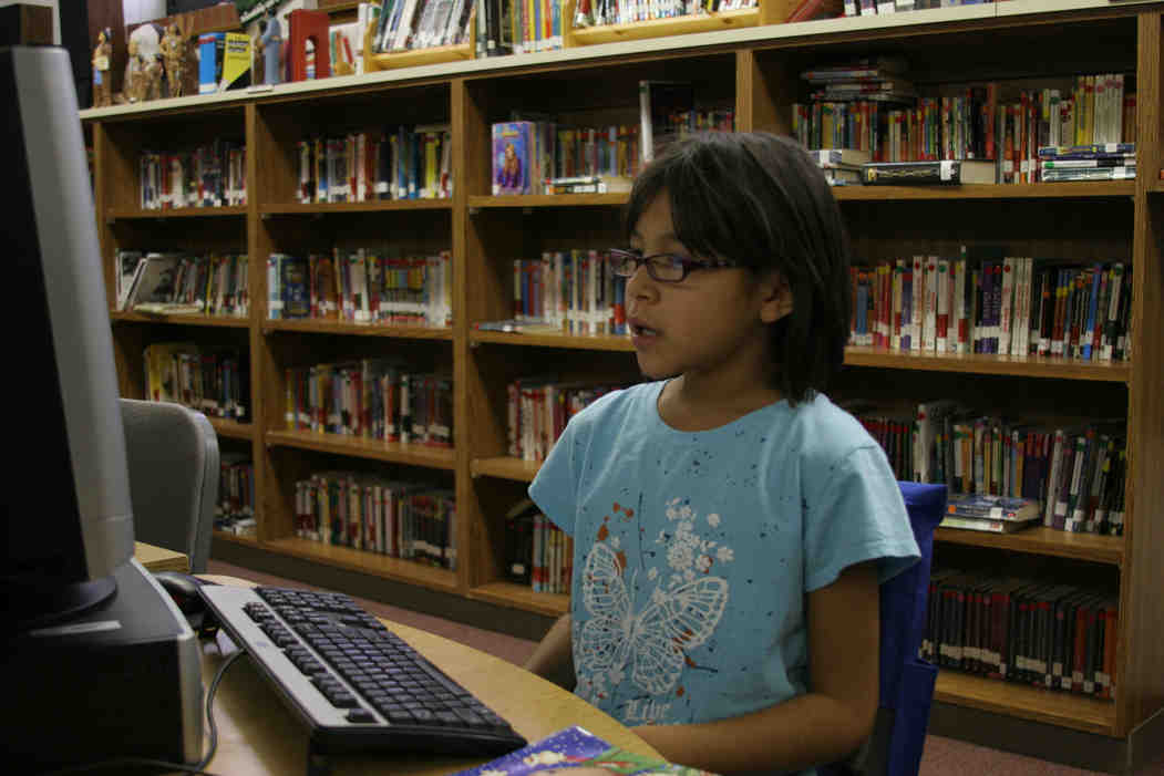 Mia takes a computer quiz on the book she just finished.