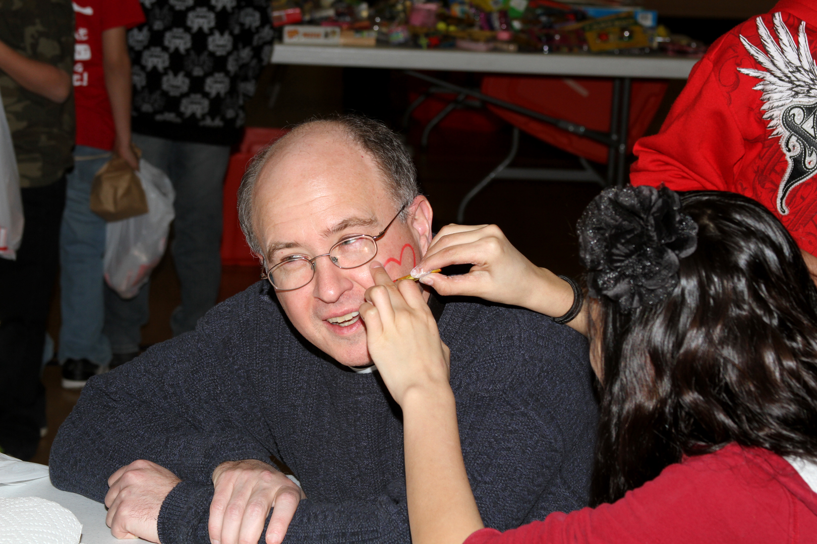 Fr. Steve, getting a heart face painted on his face!