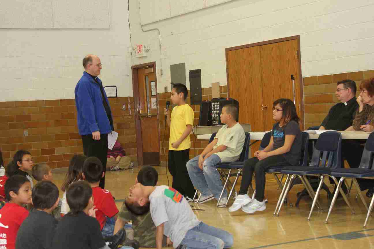 Fr. Steve and the kids participating in the Spelling Bee.