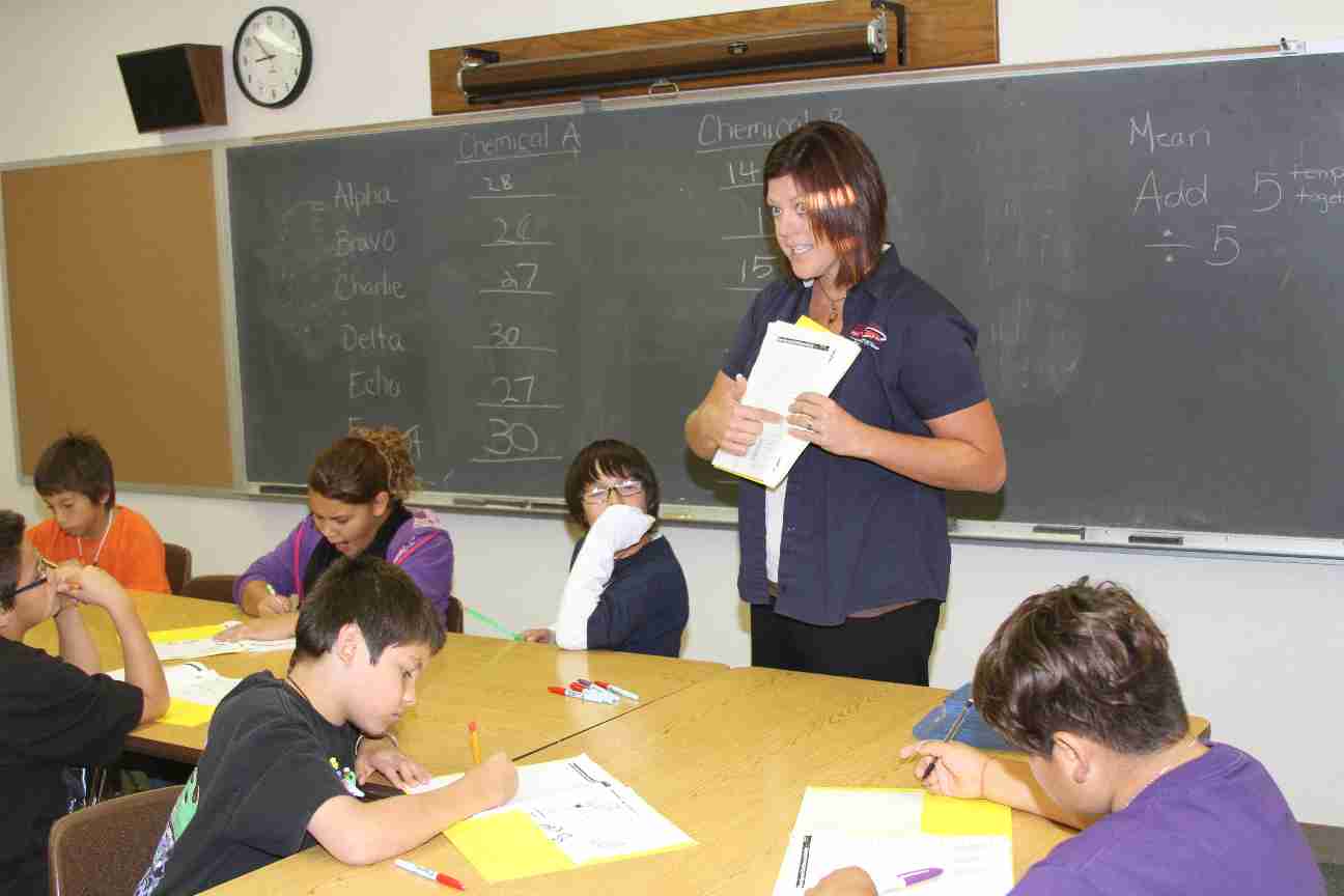 A teacher lecturing in her classroom.