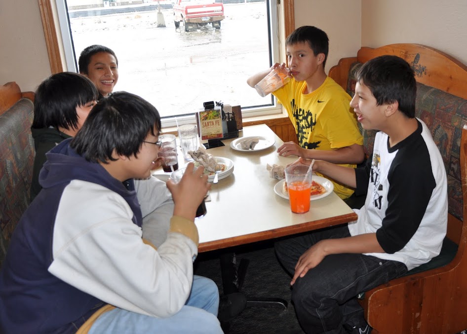 Native American boys eating at Pizza Ranch.