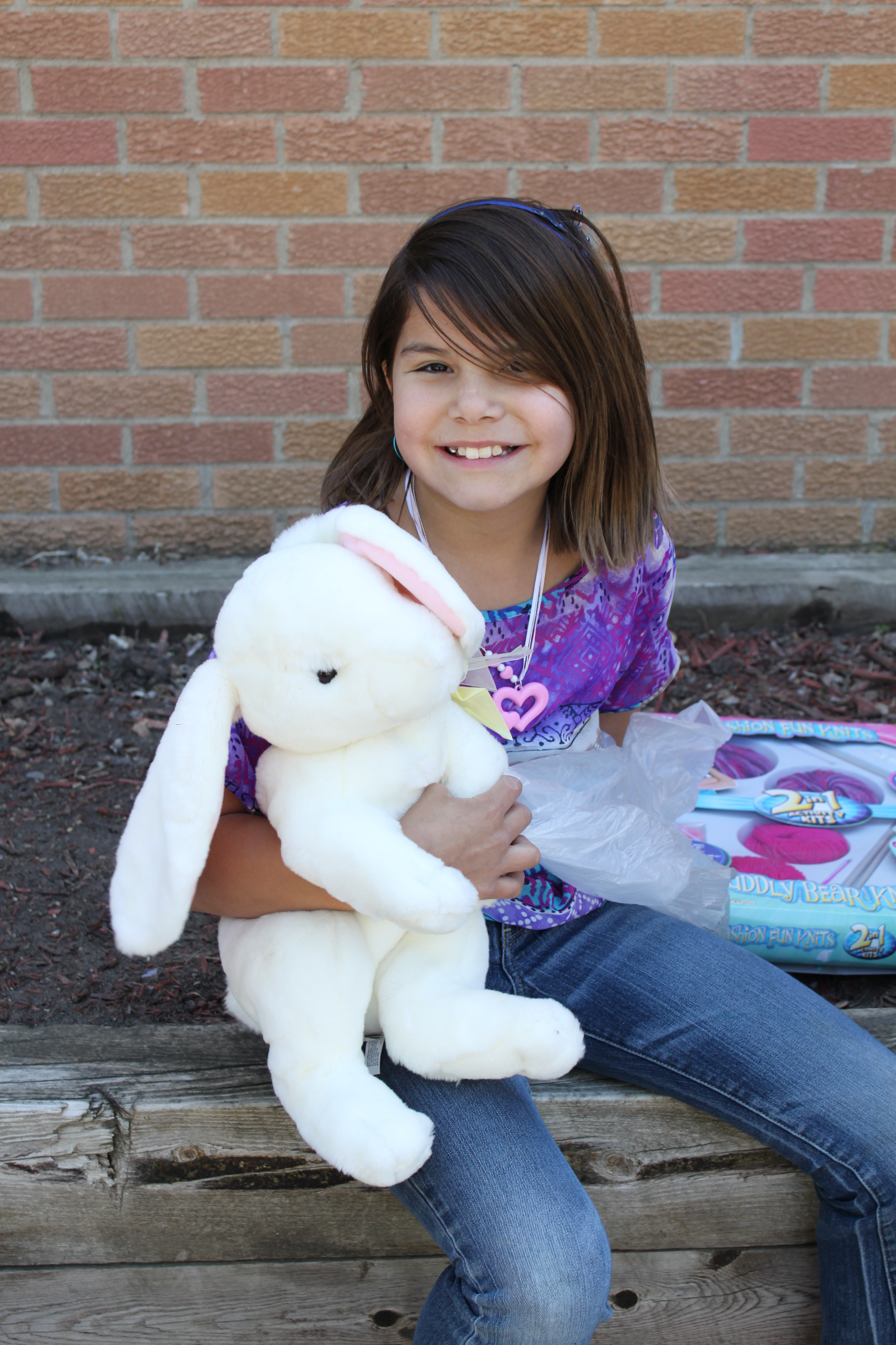 American Indian girl with a stuffed bunny.