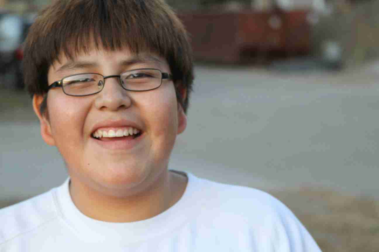 Native American boy smiles big for the camera. 