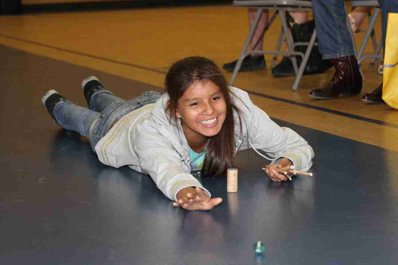 Native American girl enjoying a Lakota game.