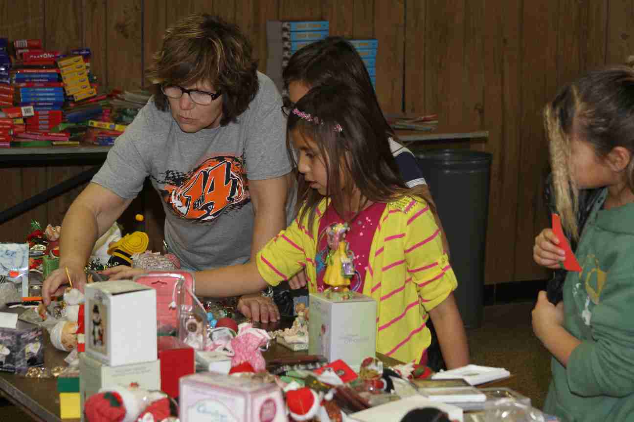 Houseparents help students choose gifts for their families.