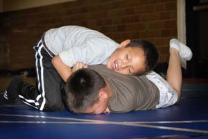 Native American students practice wrestling