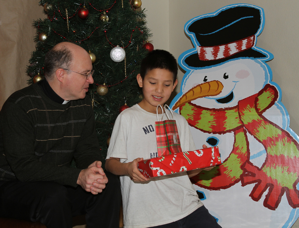 Fr. Steve and Trenton chat at St. Joseph's Indian School's Christmas store.