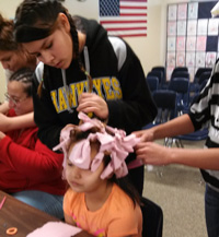 The older Lakota girls fixed hair for the younger girls.