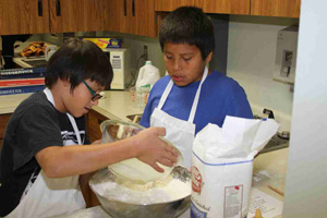 The Native American children at St. Joseph’s Indian School learn life skills like cooking. 