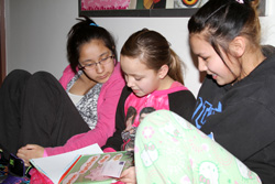 The older Lakota students enjoy reading to younger children on Dr. Seuss’ birthday. 