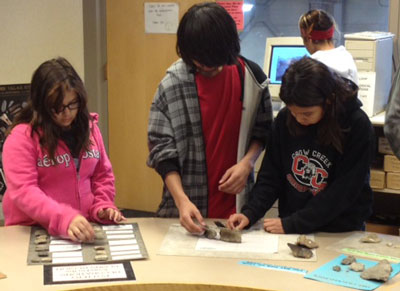 St. Joseph’s students sort through artifacts trying to distinguish between bone and rock. 