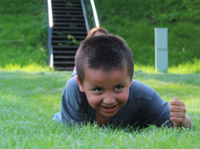 Lakota boy imitating snake