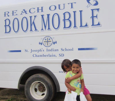 St. Joseph’s Bookmobile travels to the reservation giving away free books each summer. 