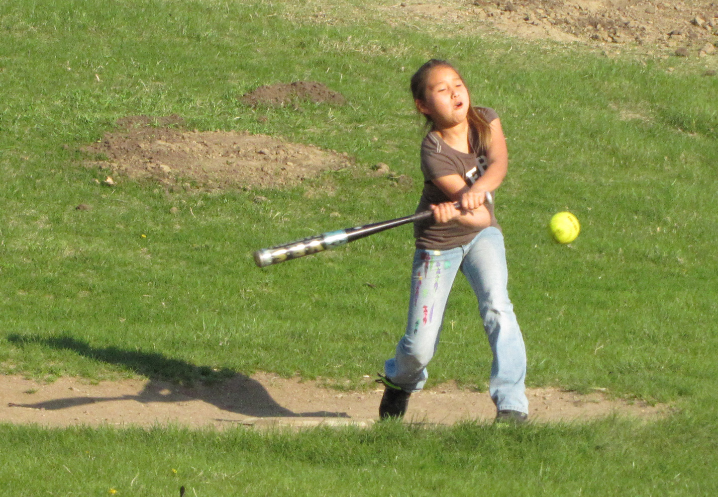 St. Joseph’s students learn basic softball skills – hitting, catching and throwing. 