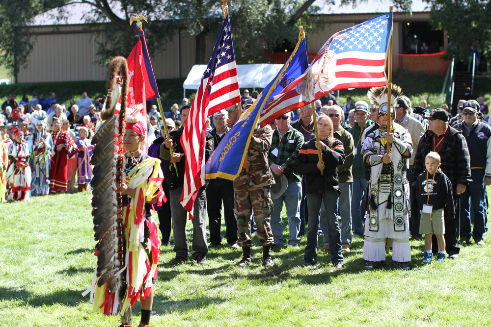 Grand Entry at powwow is led by St. Joseph’s Eagle Staff Bearer and veteran alumni carrying flags. 