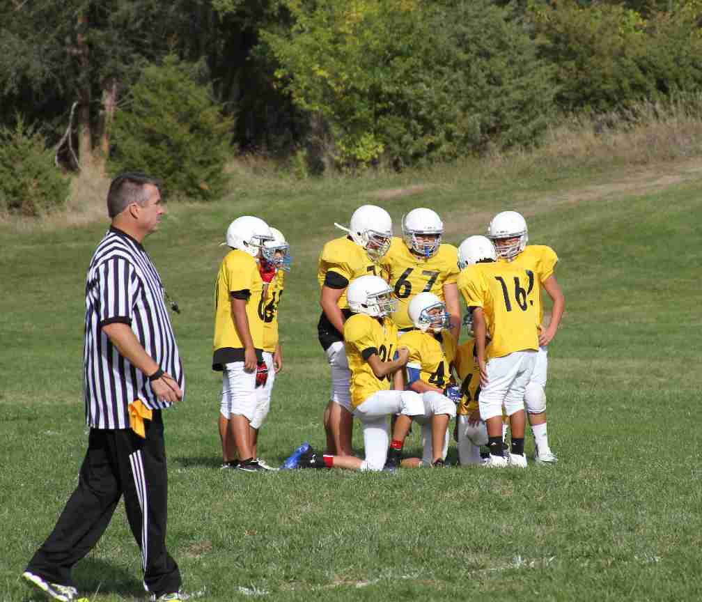 St. Joseph’s Braves take a break between plays on the football field. 