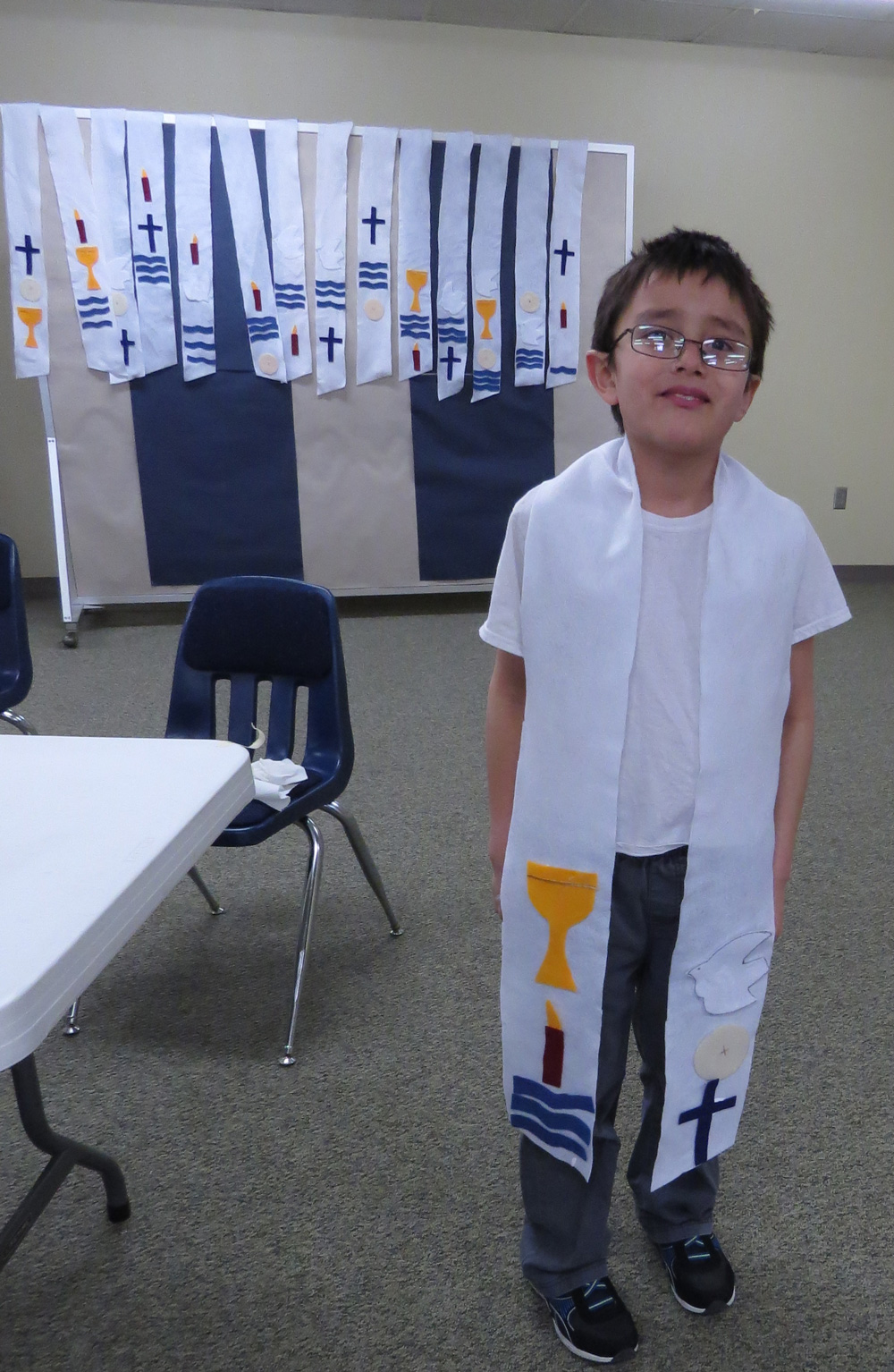 The students made stoles decorated with symbols relating to the sacraments and will wear them when they are baptized.