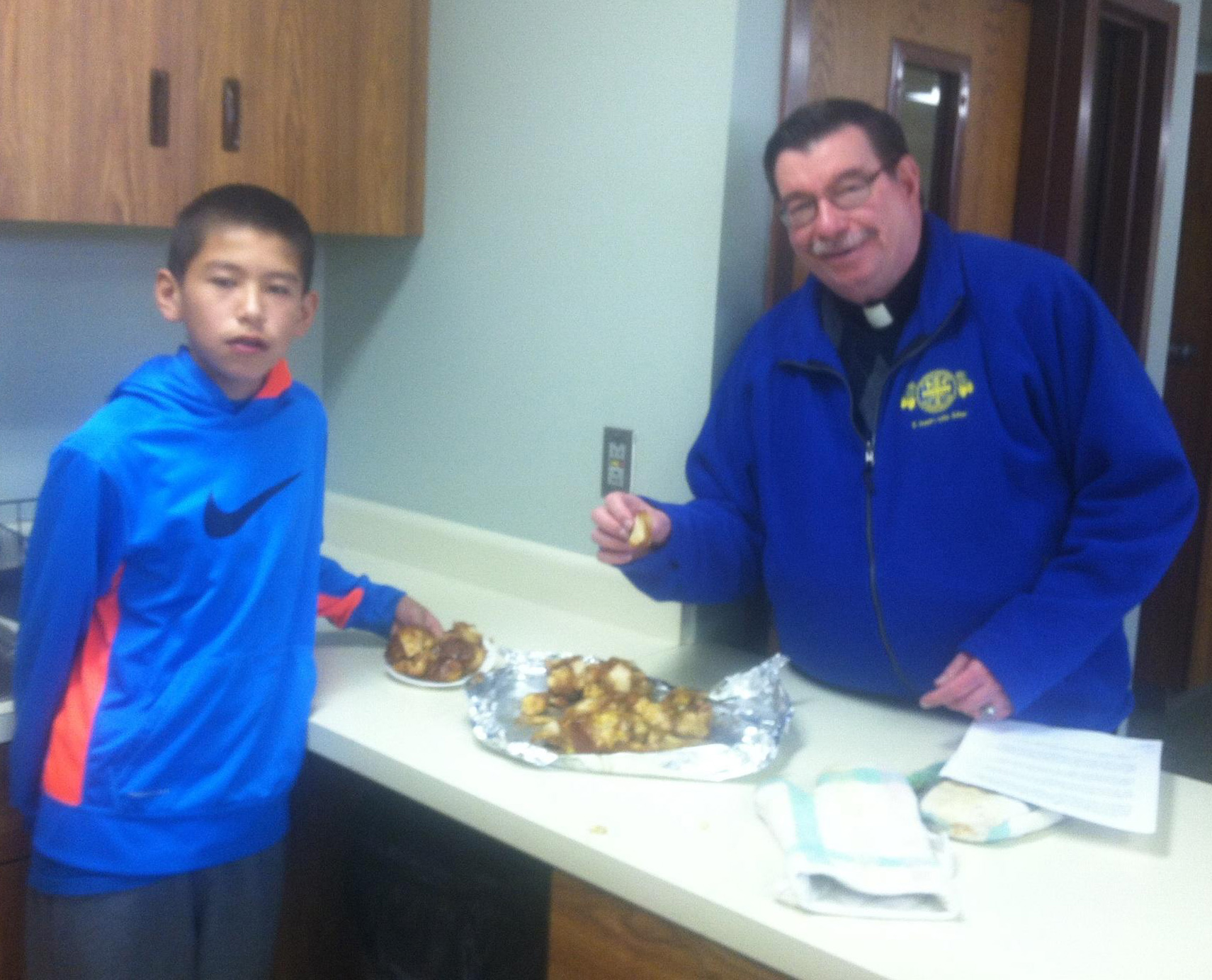 Fr. Anthony sampled the monkey bread the sixth graders were baking in class. 