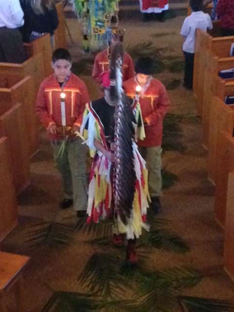 The Eagle Staff leads the procession into Mass at Our Lady of the Sioux Chapel. 