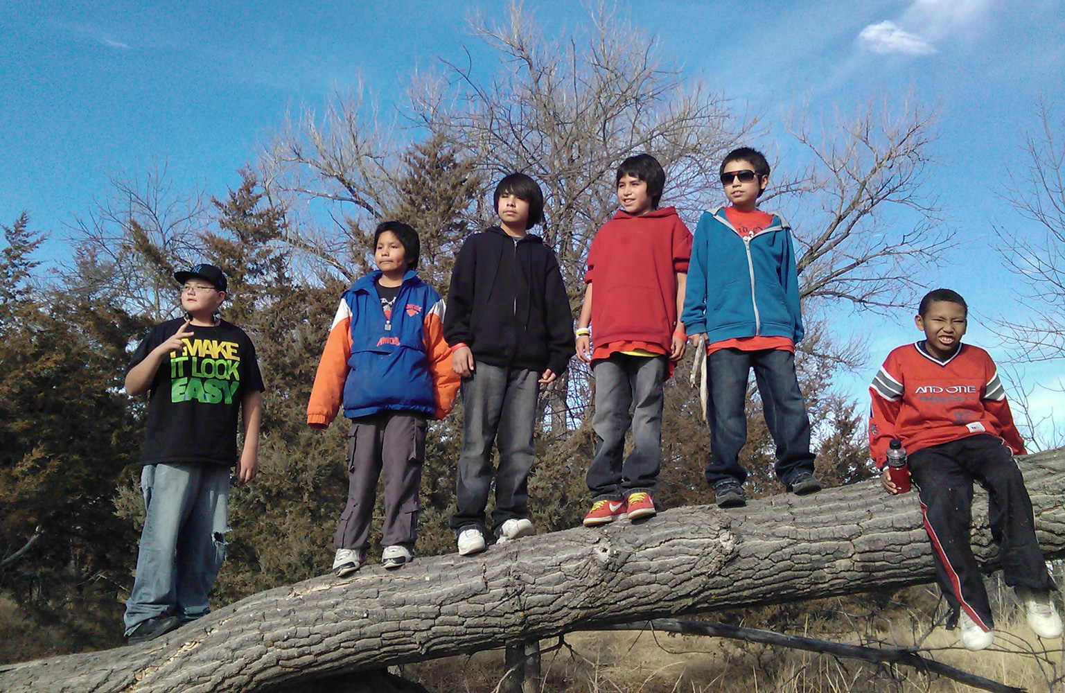 Each year on their hike, the boys stop at the same tree for a picture. 
