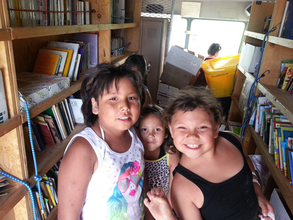  Lakota (Sioux) children choose books to take home. 