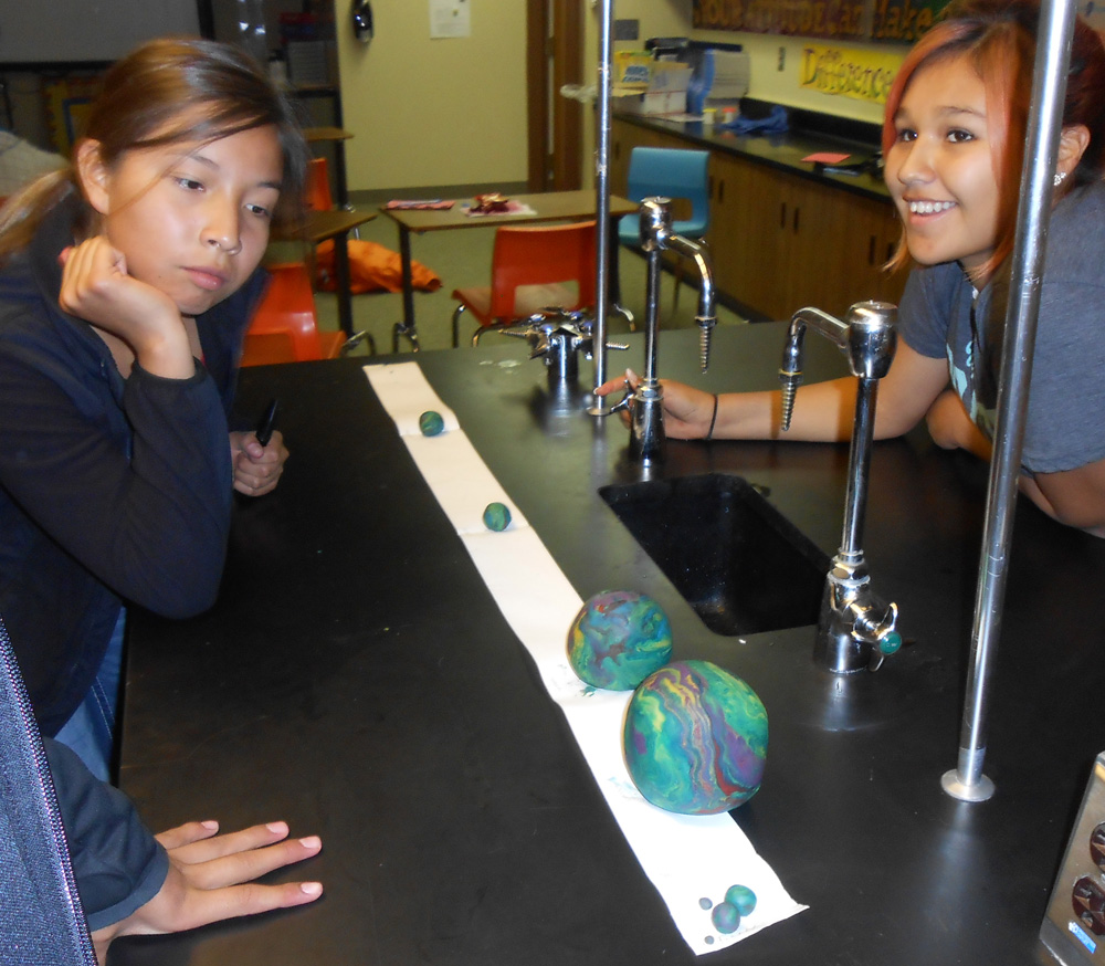 Students made planets out of play dough to create a “pocket solar system.” 