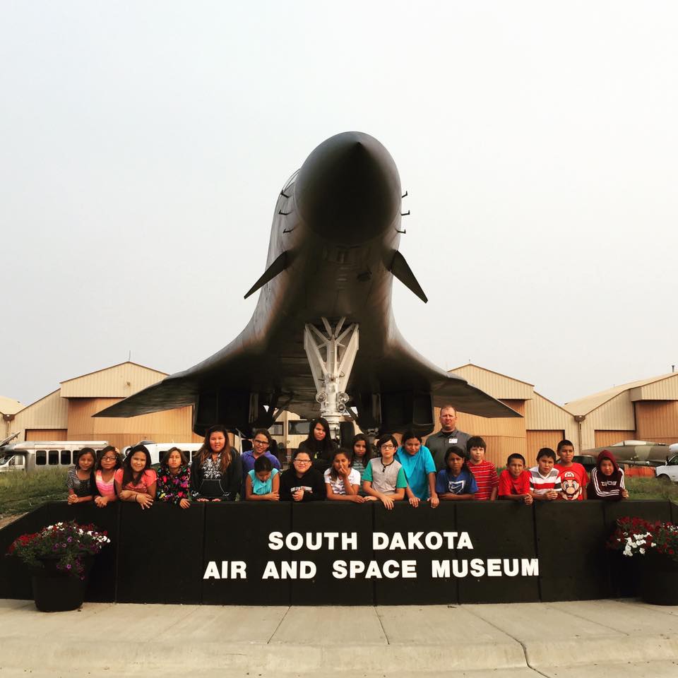 Our Lakota (Sioux) students stand behind the Air & Space Museum sign during their field trip. 