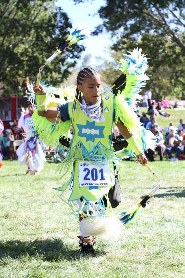 Lakota boy dances fancy dance in the powwow. 