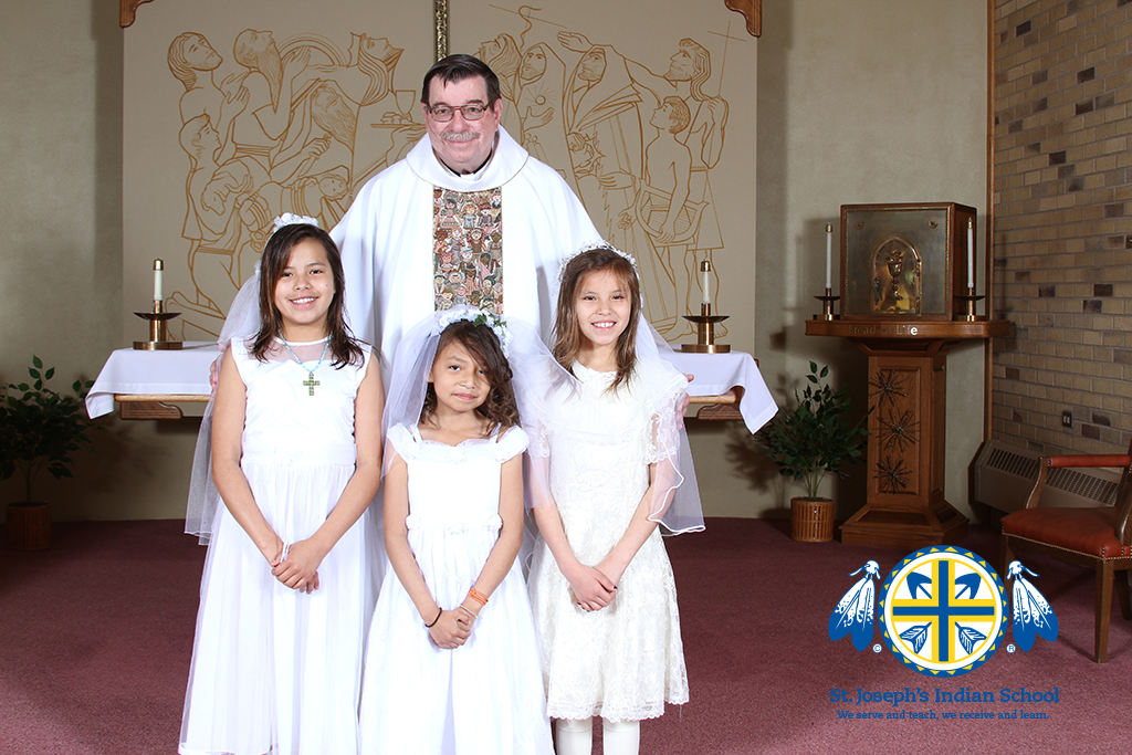 Fr. Anthony with three Lakota (Sioux) students at Our Lady of the Sioux Chapel in Chamberlain, SD. 
