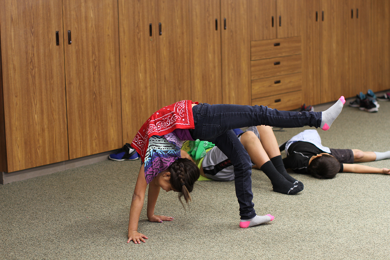 A St. Joseph's student learns how to dance with props.