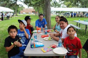 Native American students and family members enjoy a meal during the Back-to-School Picnic at St. Joseph’s. 