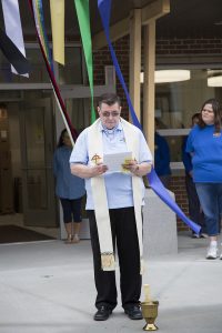 Fr. Anthony prays for Health and Family Services Center at St. Joseph's