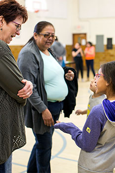 A St. Joseph’s fourth grader gestures to her visitors during the science fair. 